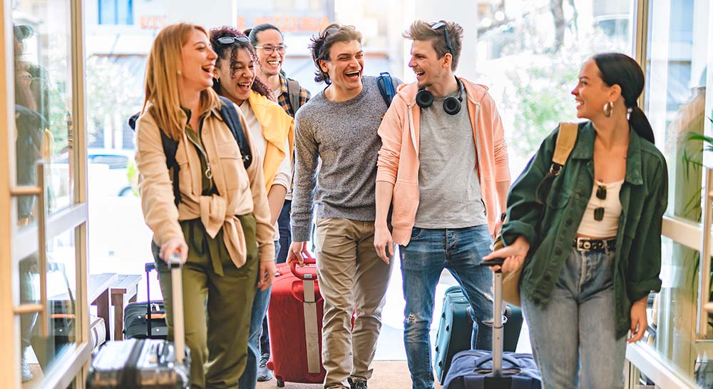 Group of students with suitcases