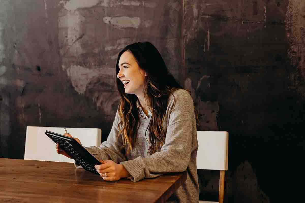 women laughing sitting at desk